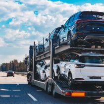 Car transport truck driving on highway road. Car Carrier Trailer on asphalt road